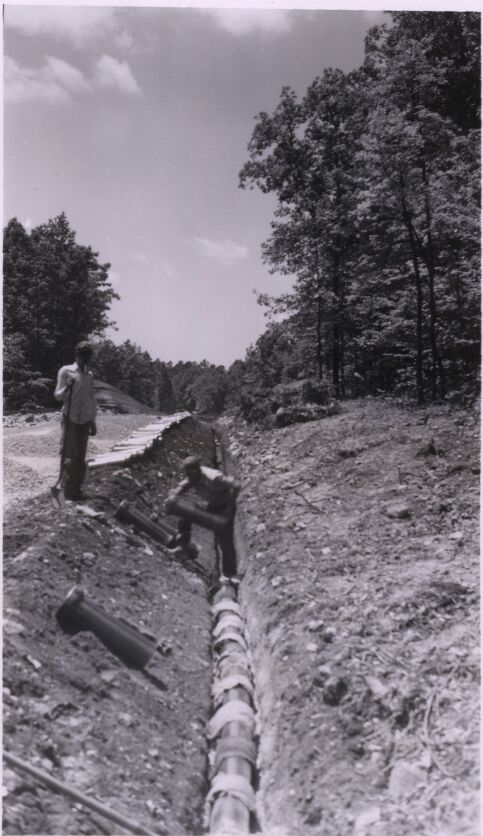 Laying clay pipe underdrain at Station 306+60