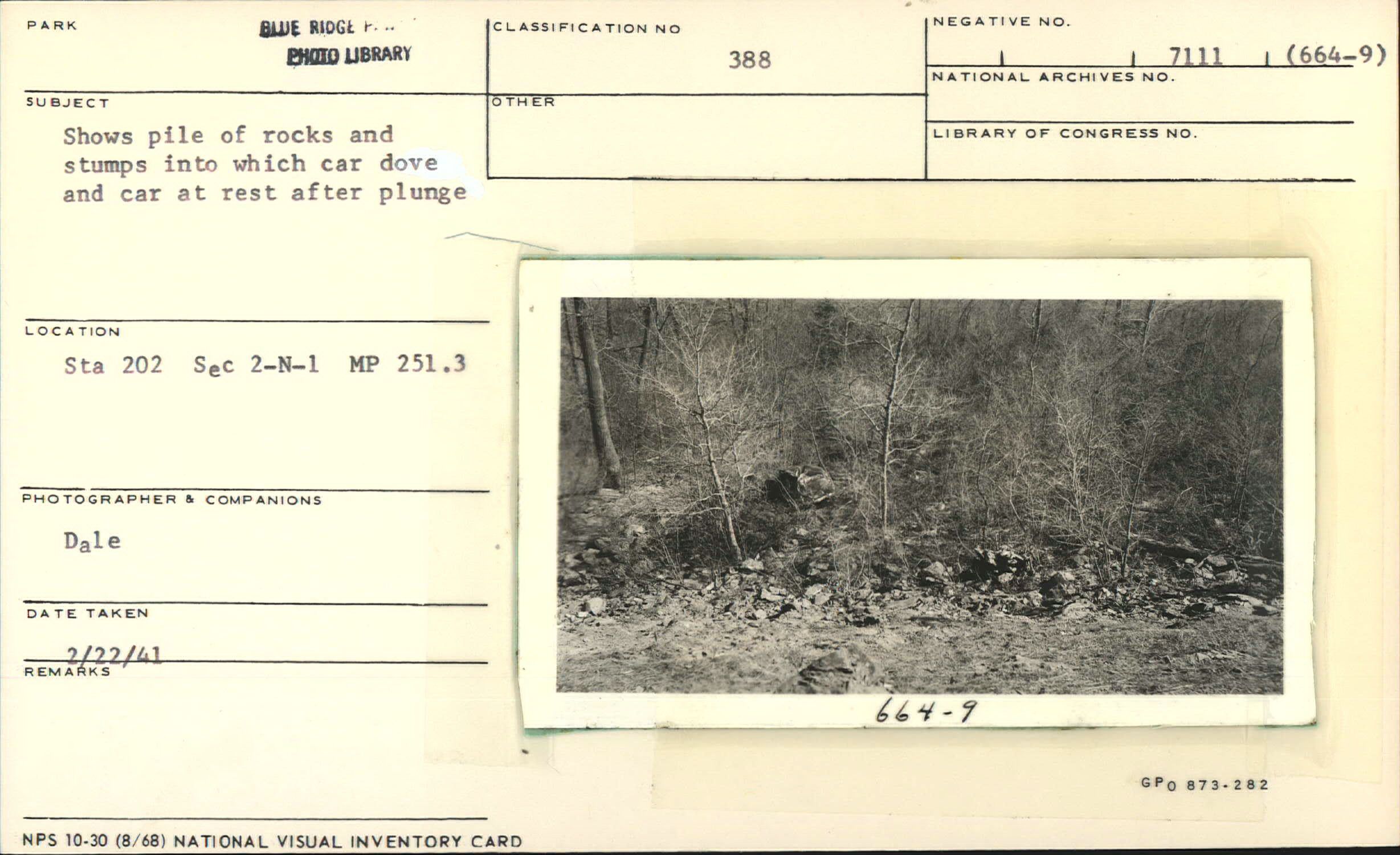 Shows pile of rocks and stumps into which car dove and rested after plunge