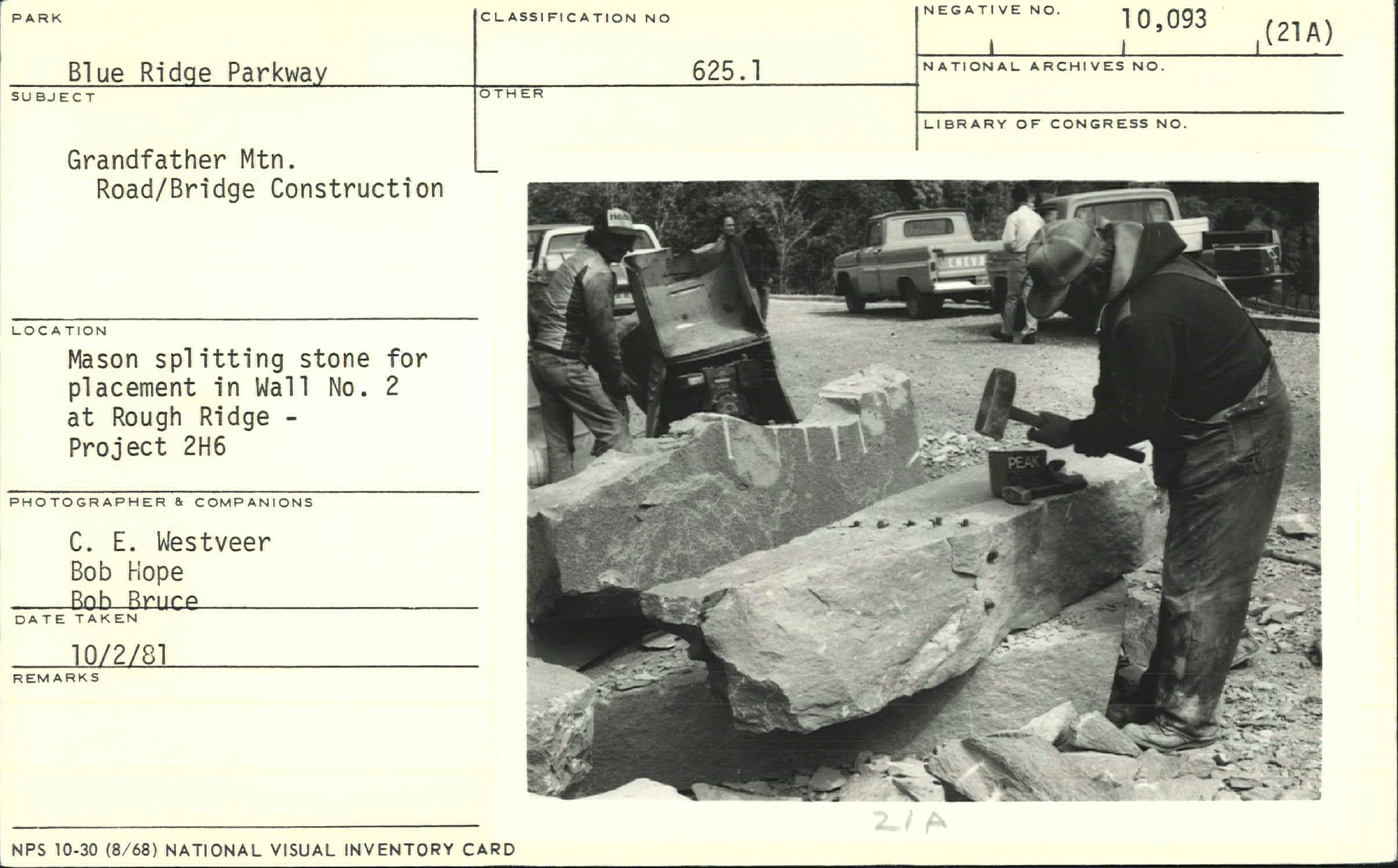 Mason splitting stone for placement in Wall No. 2 at Rough Ridge