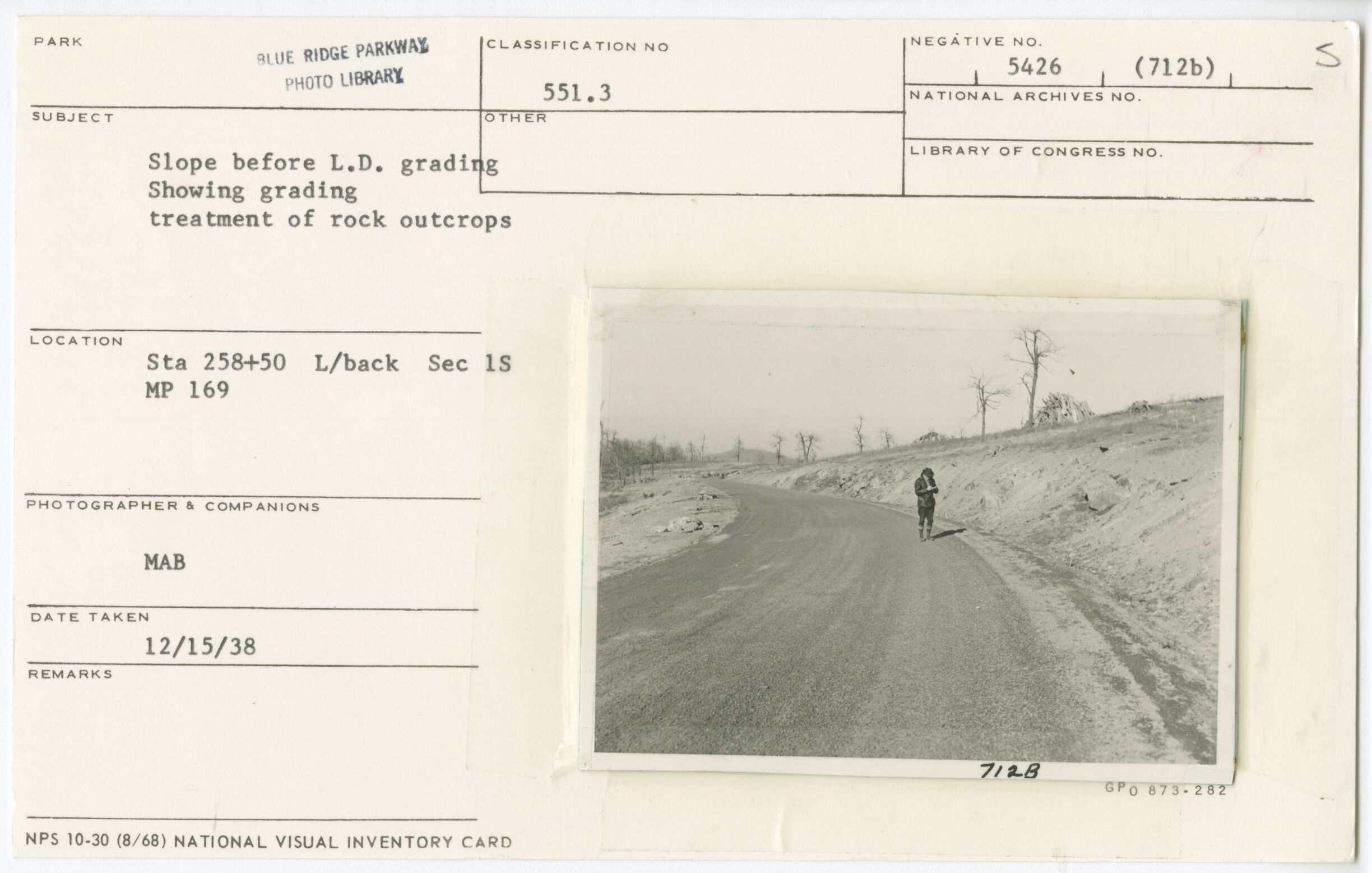 Slope before L.D. grading showing treatment of rock outcrops