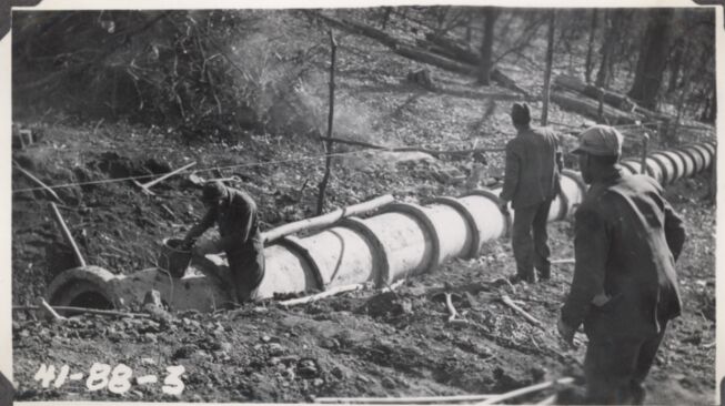 Laying 30' culvert pipe, Station 122+34