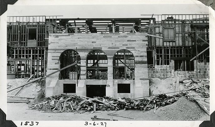 This is an historic black and white photograph from the Scotty's Castle Historic Photograph Collection, Death Valley National Park of Scotty's Castle Main House, looking north. Wood framing in preparation for installing hollow tile walls. Great Hall roof pearlings in place. March 6, 1927. Photographed by Mat Roy Thompson.