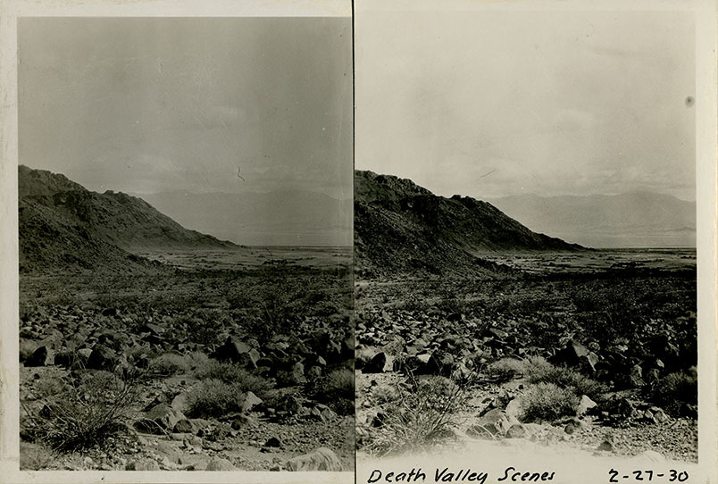 This is an historic black and white photograph from the Scotty's Castle Historic Photograph Collection, Death Valley National Park of Death Valley scene. Mountains in foreground and distant background with rocks scattered throughout. Exact location unknown. February, 27, 1930. Photographed by Mat Roy Thompson.