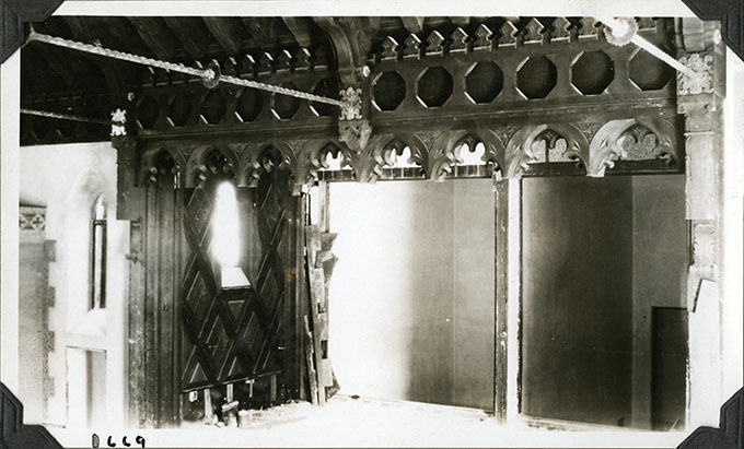 This is an historic black and white photograph from the Scotty's Castle Historic Photograph Collection, Death Valley National Park of Scotty's Castle Annex Upper Music Room looking north towards stage, 1st Pipe Room (West), and 2nd Pipe Room (East). Circa 1928. Photographed by Mat Roy Thompson.