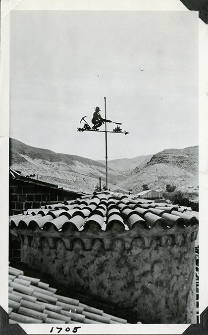 This is an historic black and white photograph from the Scotty's Castle Historic Photograph Collection, Death Valley National Park of Scotty's Castle Annex Foyer Tower Weather Vane of miner. Circa 1928.  Possibly photographed by Mat Roy Thompson.