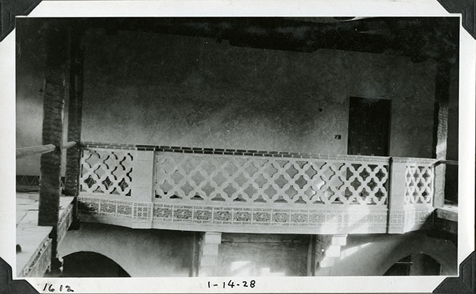This is an historic black and white photograph from the Scotty's Castle Historic Photograph Collection, Death Valley National Park of Scotty's Castle Main House Gallery. Looking west at decorative railing above Great Hall. January 14, 1928. Photographed by Mat Roy Thompson.