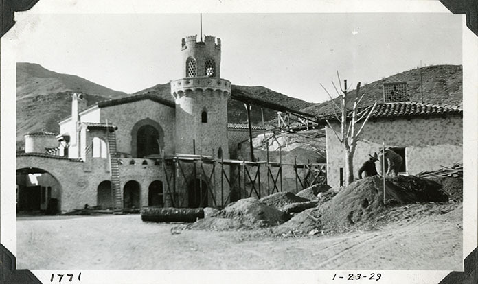 This is an historic black and white photograph from the Scotty's Castle Historic Photograph Collection, Death Valley National Park of Scotty's Castle Annex with construction ramps to Upper Music Room and Observation Tower. January 23, 1929. Photographed by Mat Roy Thompson.