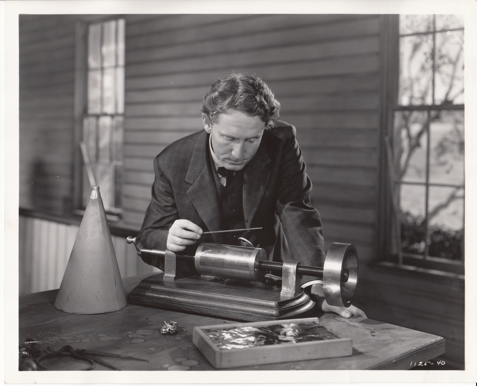 Movie still from "Edison, the Man," Spencer Tracy as Thomas Edison, demonstrating the first phonograph.