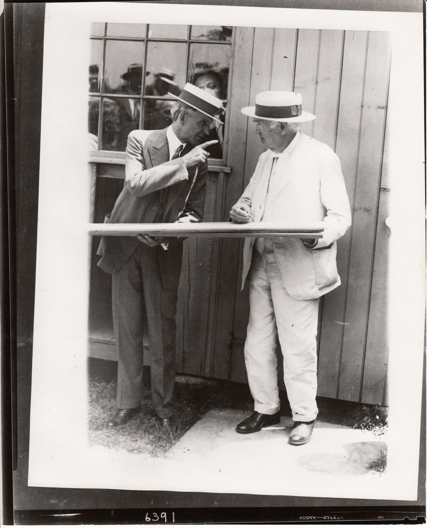 Henry Ford and Thomas Edison autographing board at presentation of Glass House.