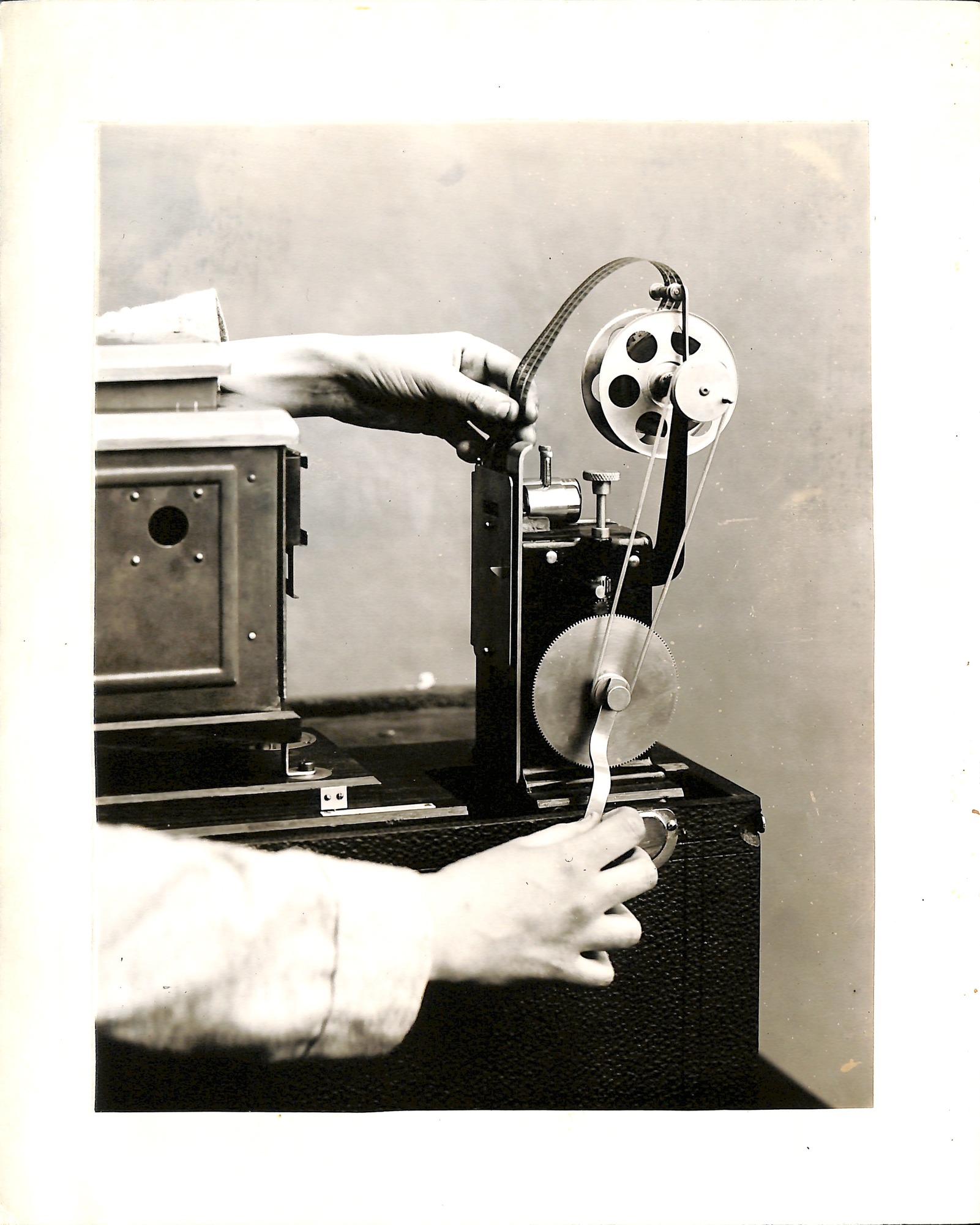 Publicity shot, girl showing lantern slide projector on Edison home projecting kinetoscope.