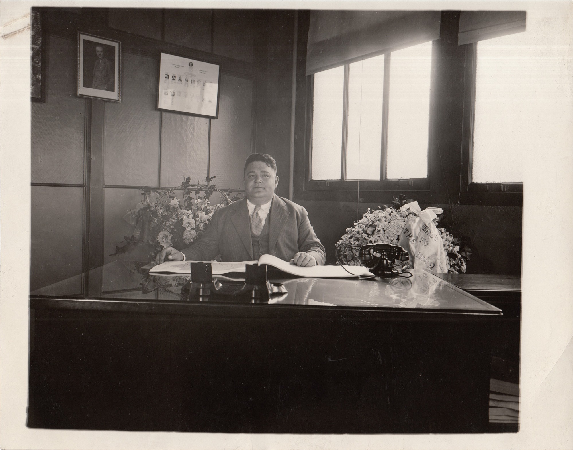 Portrait of William Hildebrand, traffic manager at his desk.