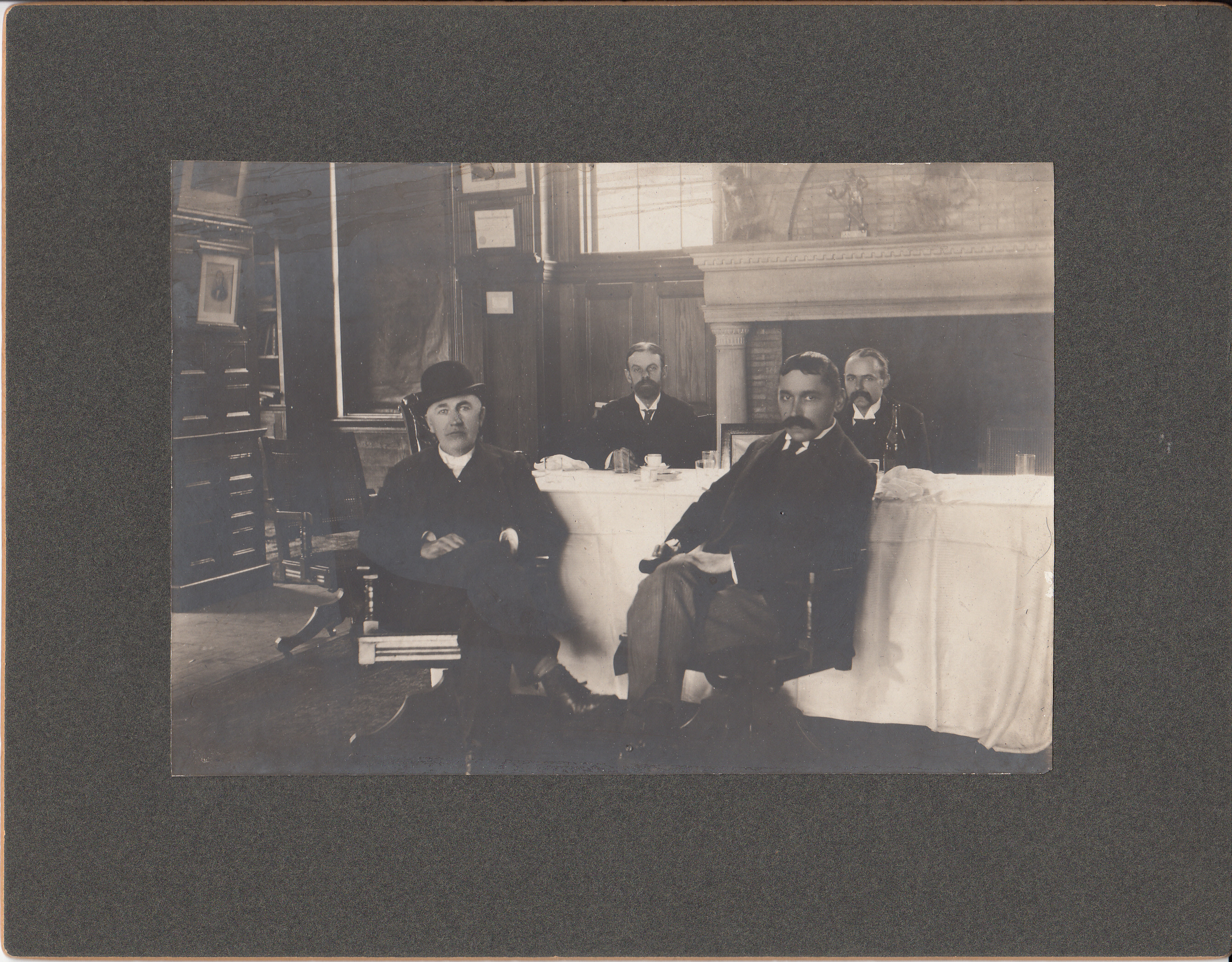 Thomas Edison, Francis R. Upton, T.F. Randolf, and an unidentified man seated at a dining table in the library of Edison's West Orange Laboratory.