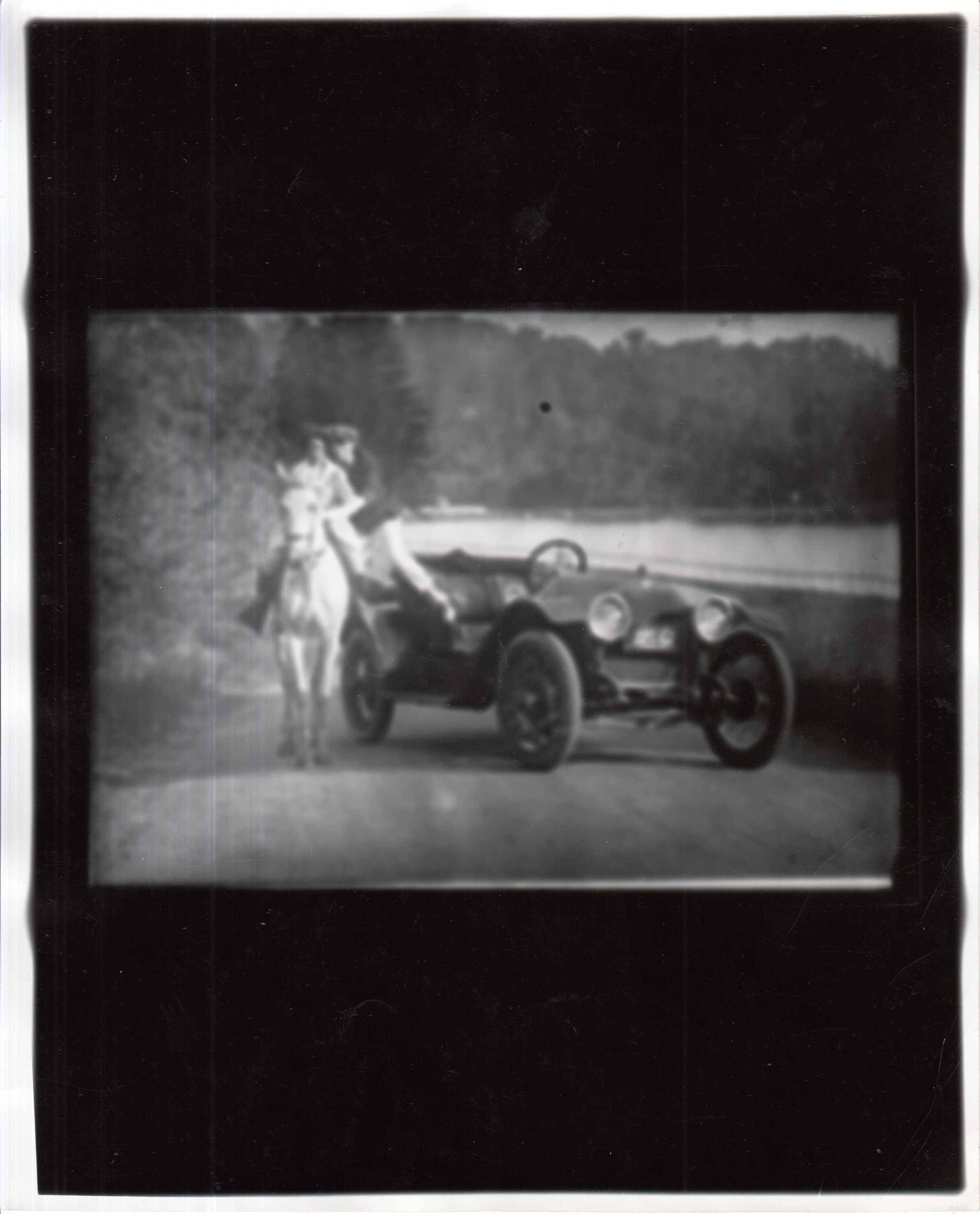 Movie frame, man jumping from automobile onto horse.