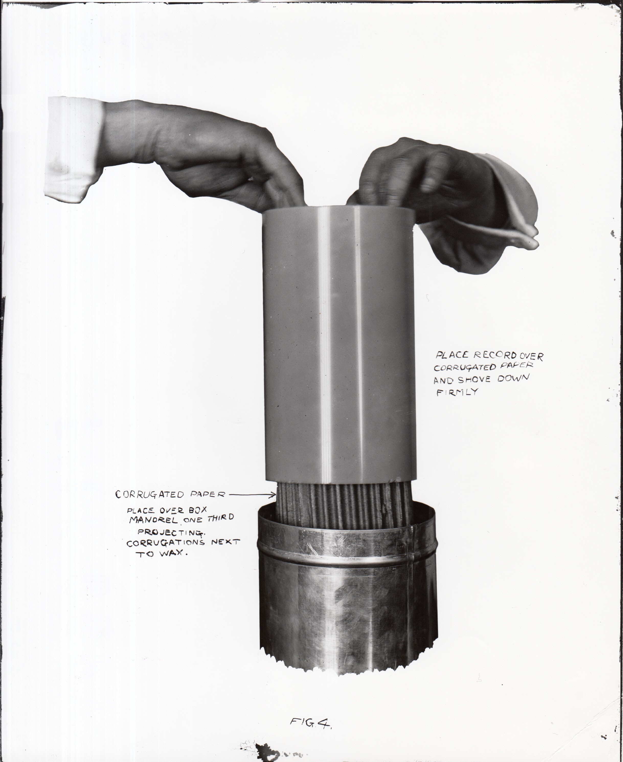 Edison kinetophone, hands placing wax cylinder recording into container.