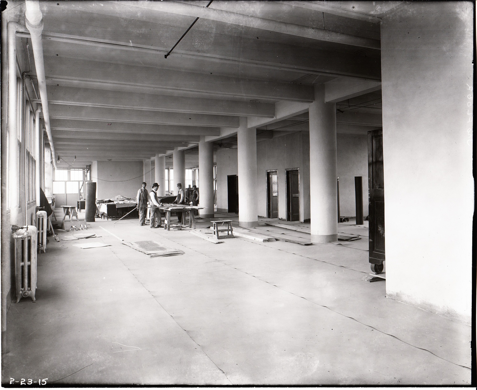Workmen on third floor of reconstructed Building 25 (Administration).