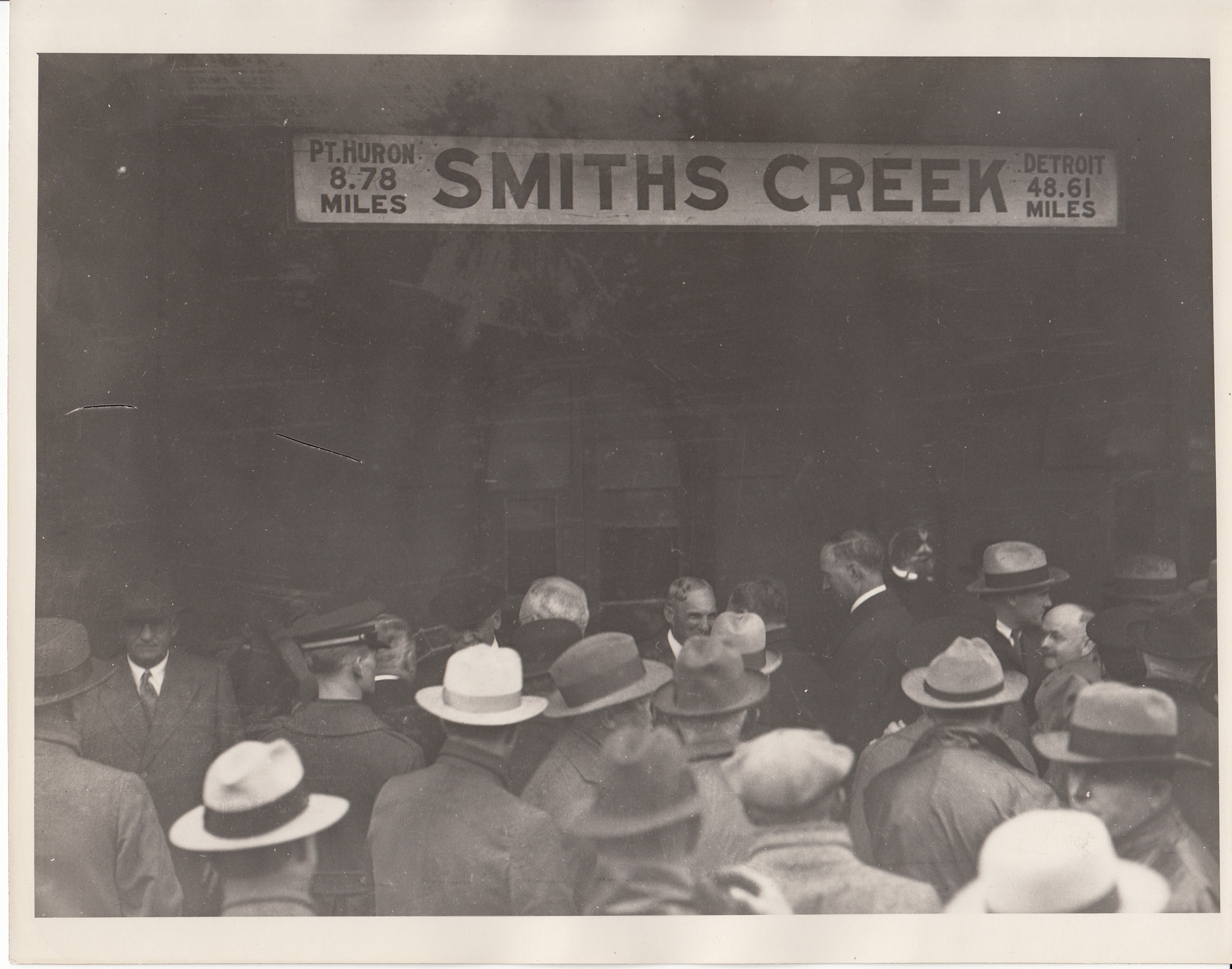 Dignitaries entering Smiths Creek train station, Henry Ford at center.