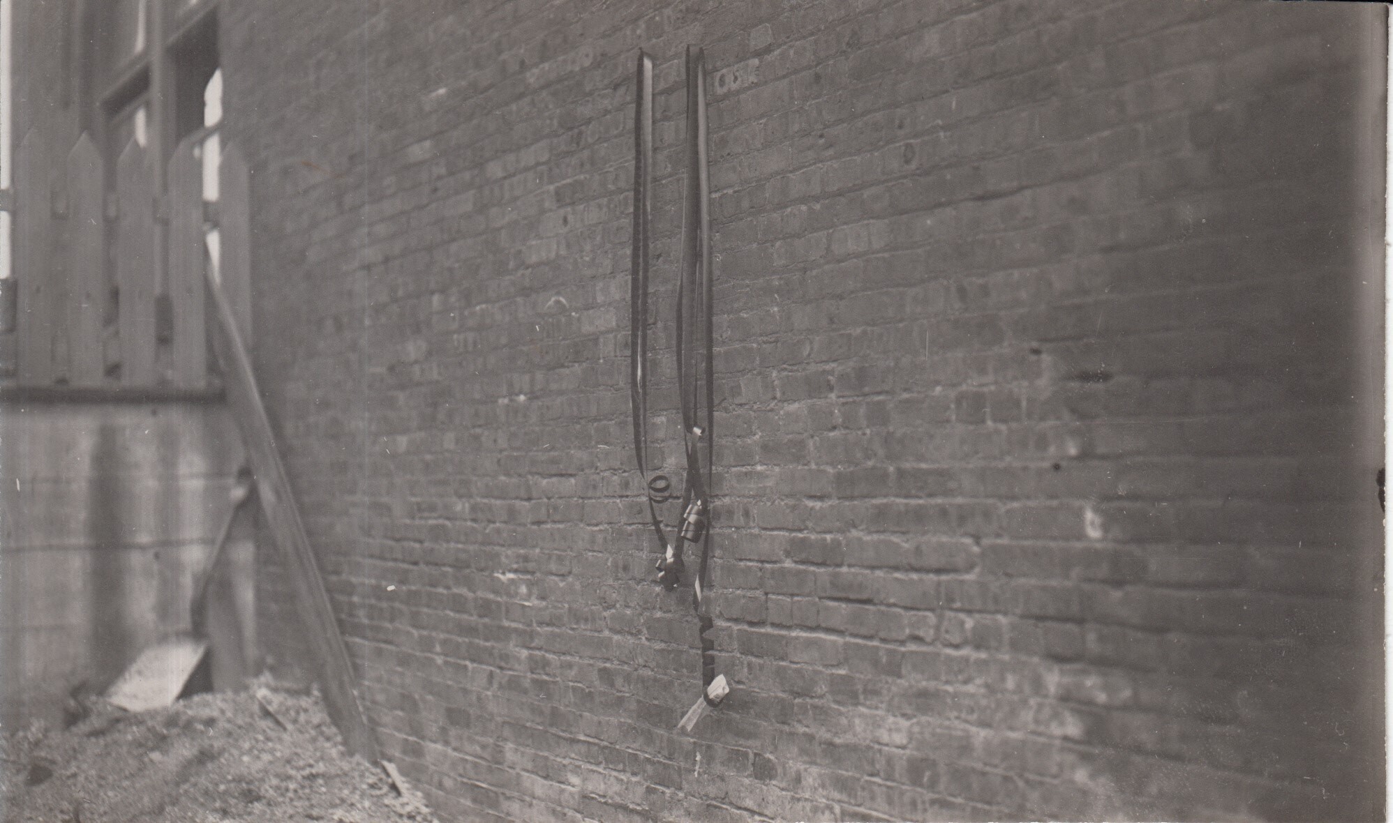 Flammability test for film used in Edison home projecting kinetoscope, film attached to wall of building, prior to ignition.