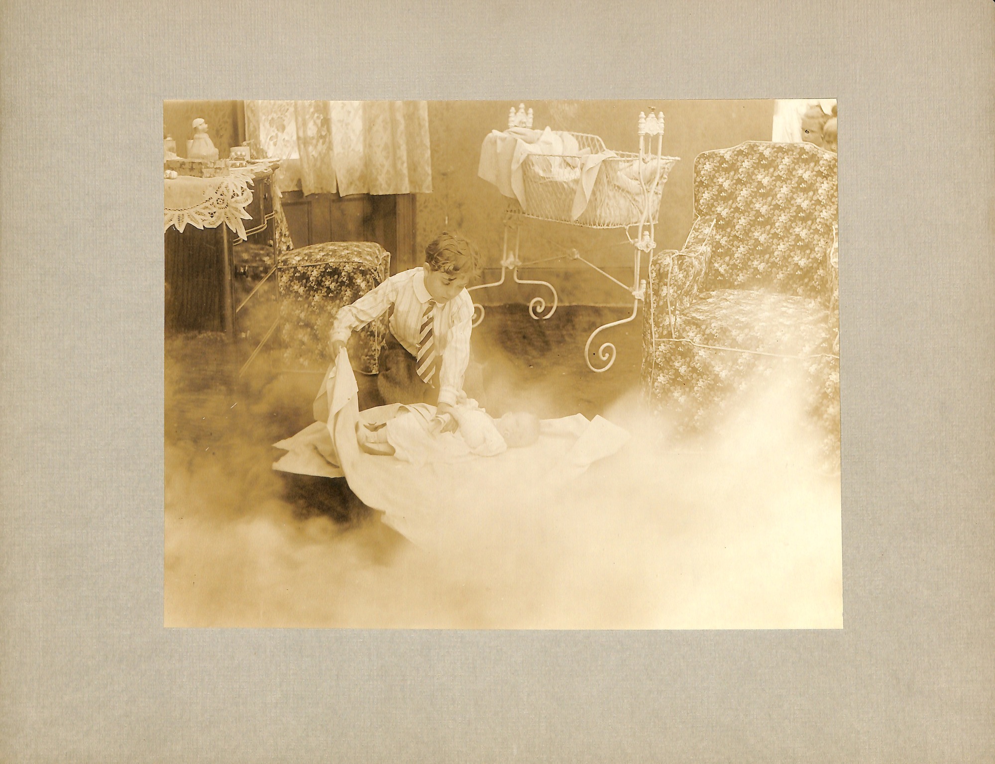 Movie still: young boy with baby.