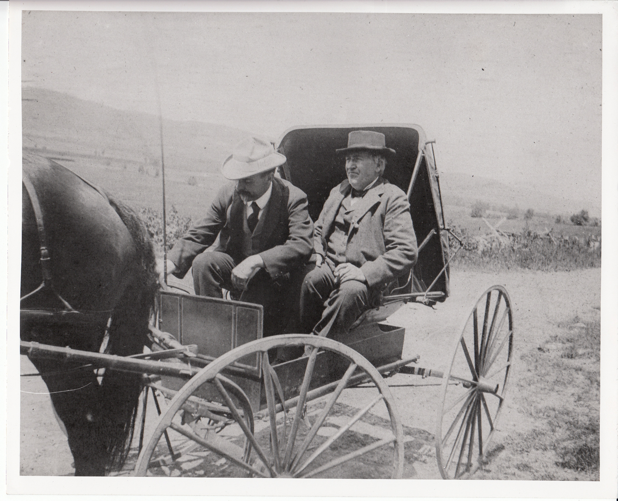 Thomas Edison and driver in horse and buggy.