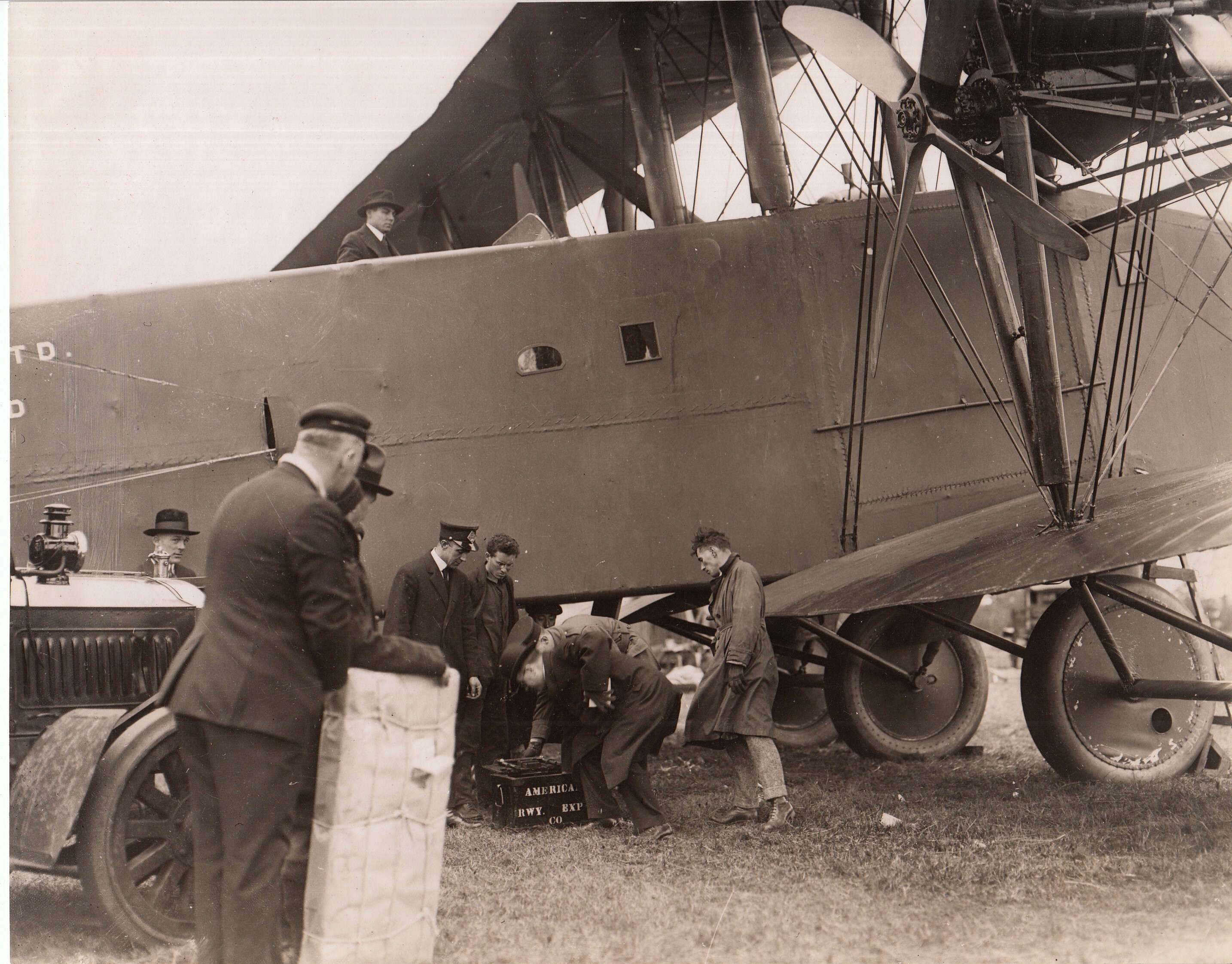Robert Cowie, of American Railway Express Co., placing valuables in safe of the Hadley-Page airplane "Atlantic" before its departure on non-stop flight from New York to Chicago.