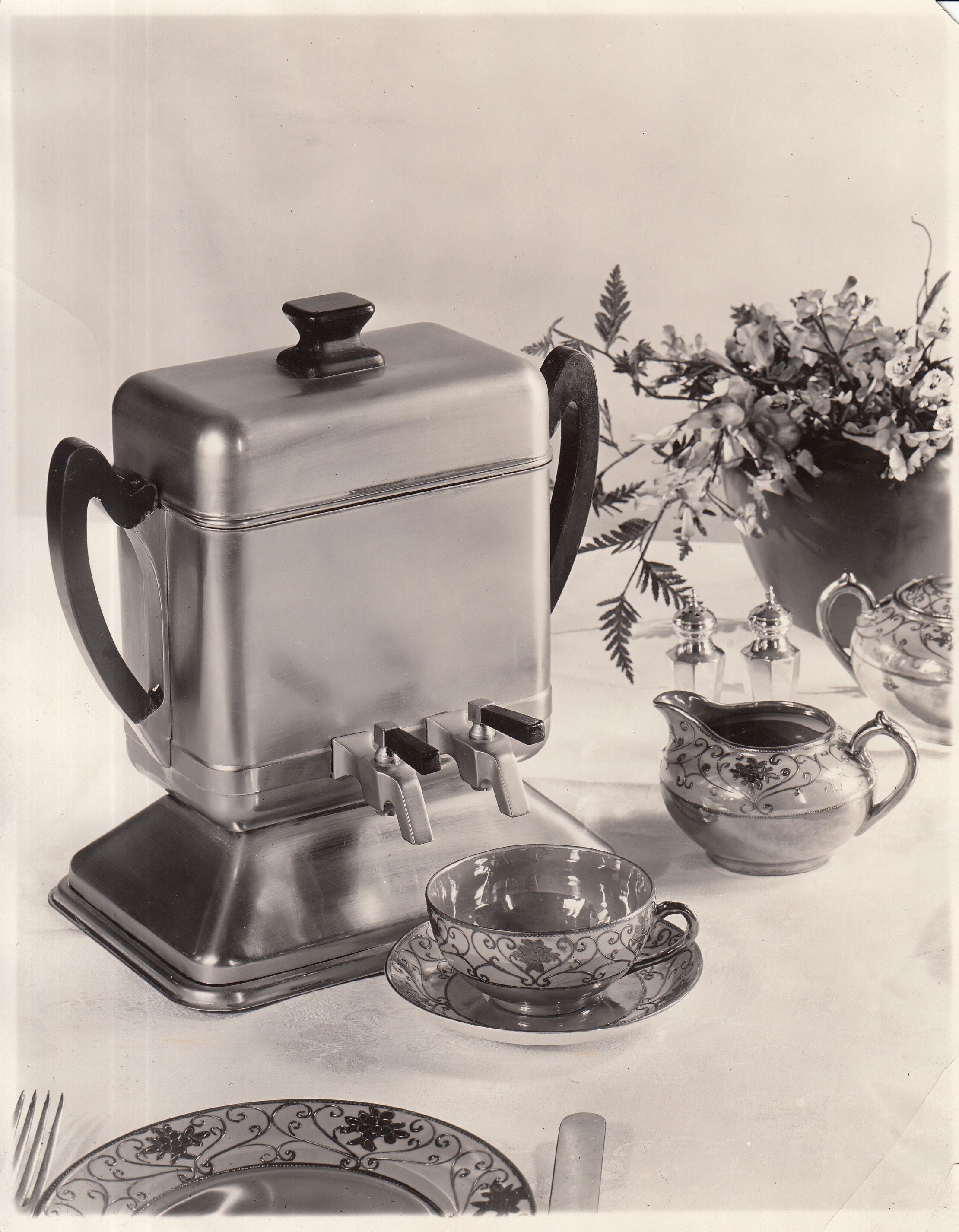 Edicraft Siphonator on table with coffee cup and creamer.