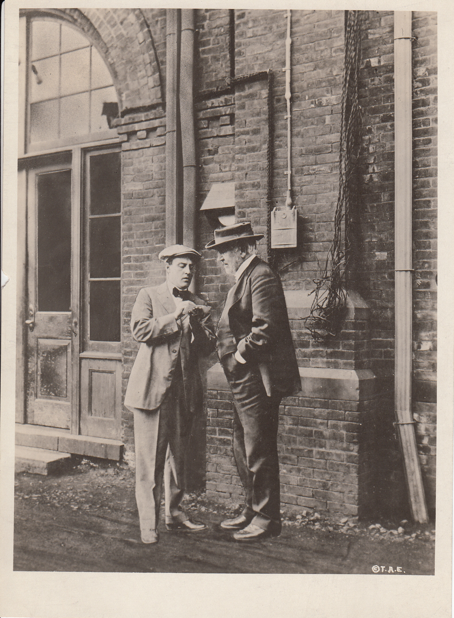 Thomas Edison dictating to Miller Reese Hutchison outside Building 5 at Edison's West Orange Laboratory.