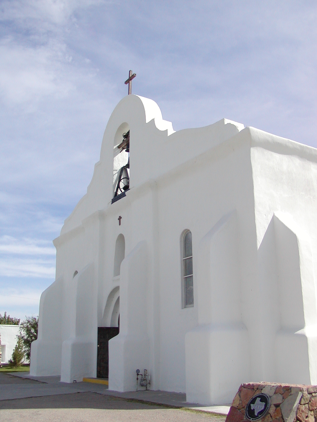 A white building close to a road.
