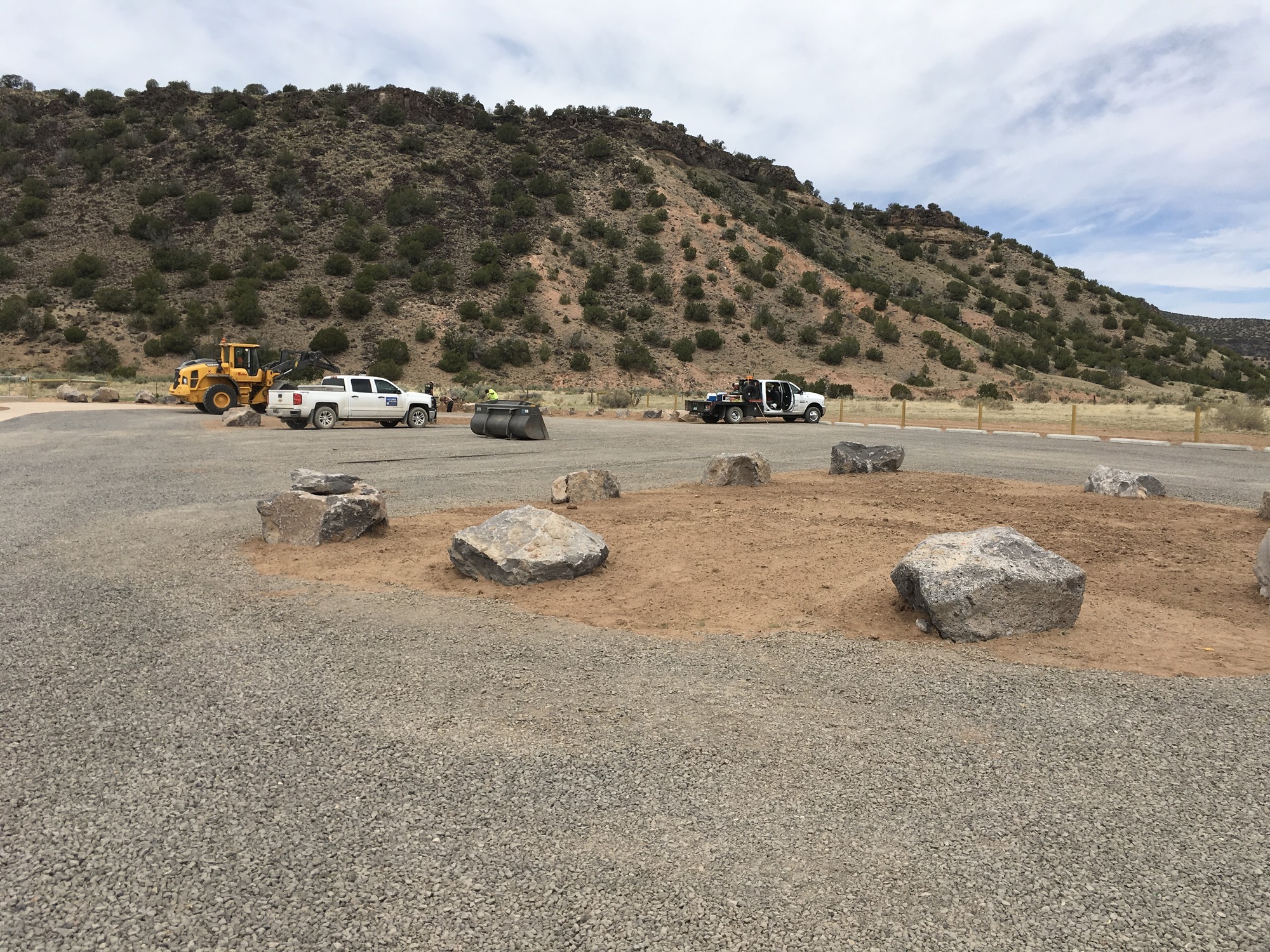 A group of rocks in the middle of a parking lot.