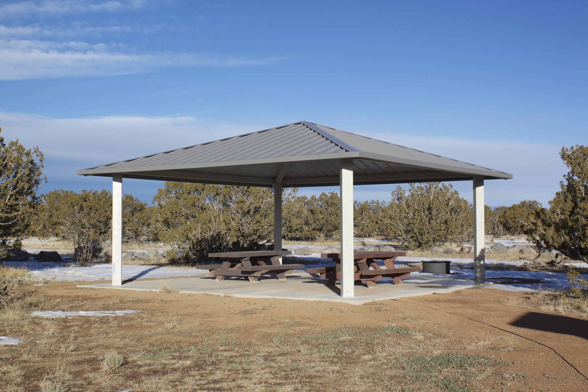 A gazebo in the middle of a field.
