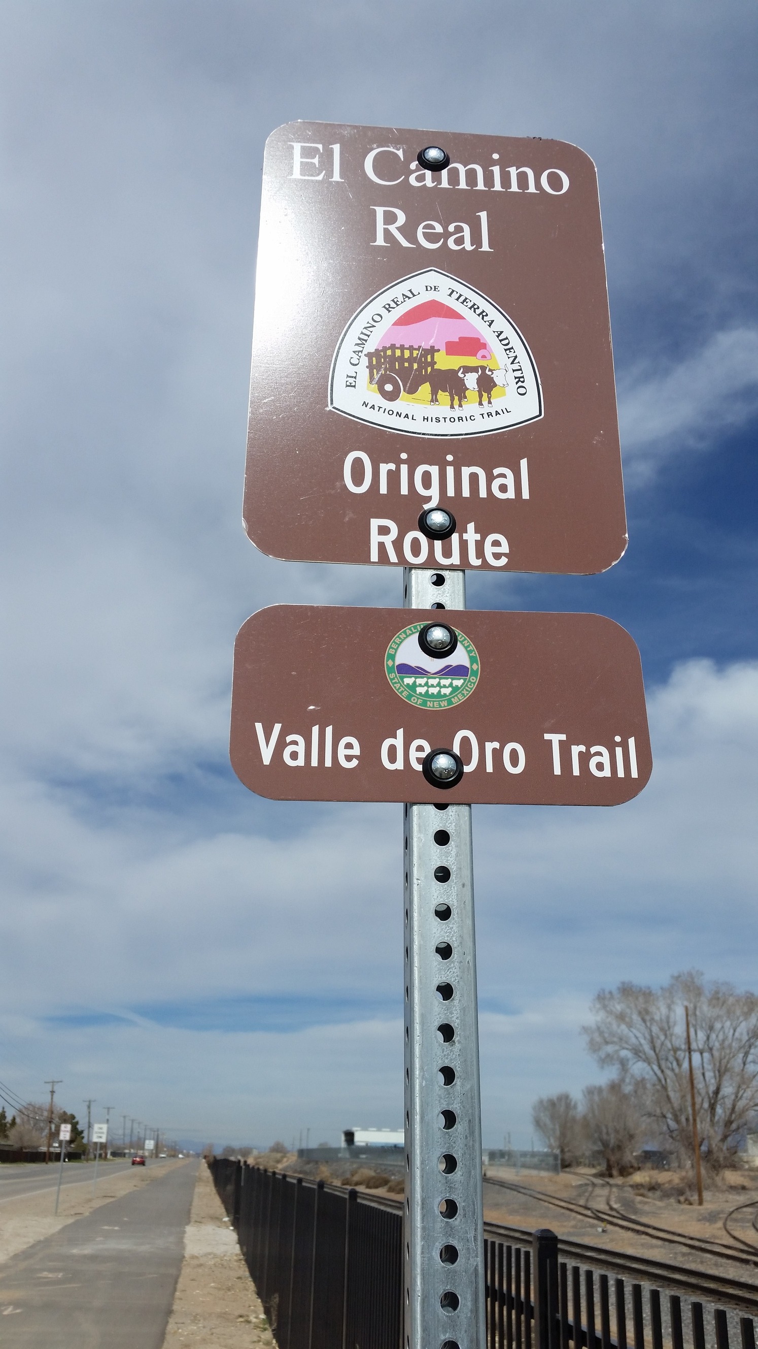 A sign with the text "El camino real original route trail" on it.