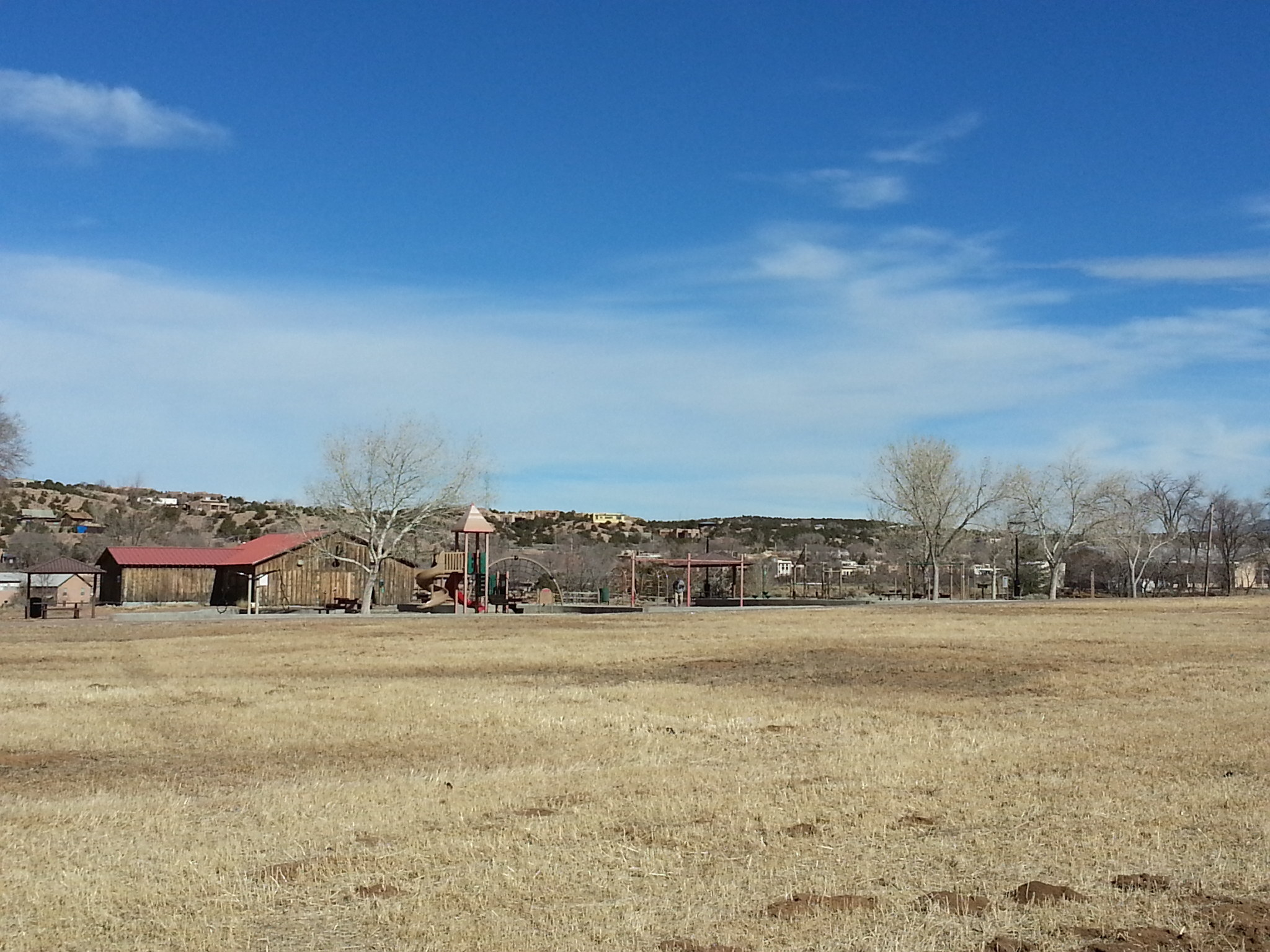 A grassy field with a building in the background.