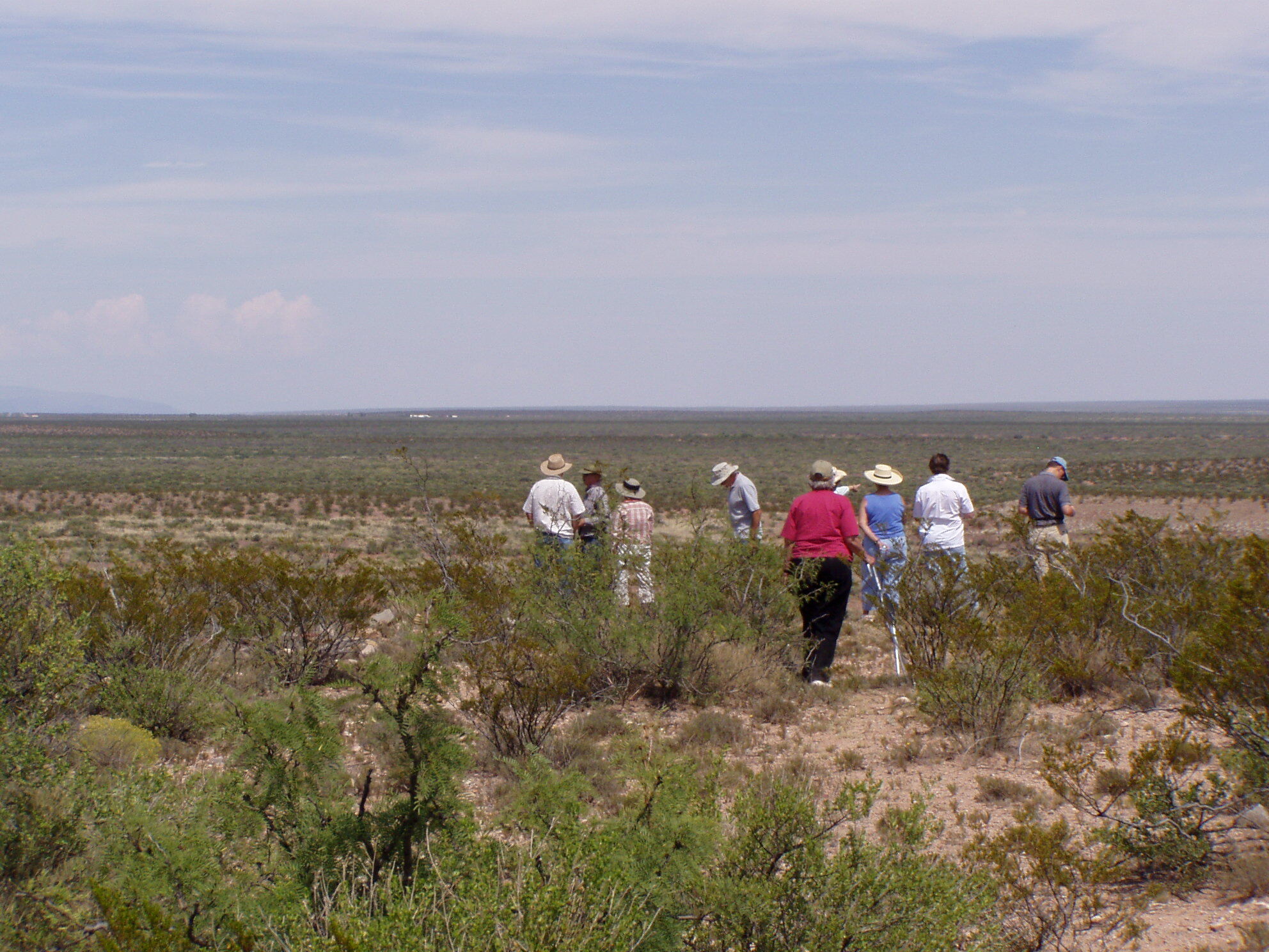A group of people standing in a field.