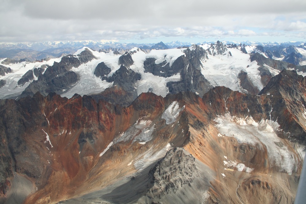 Glaciers sculpting the rust-colored peaks of the Chigmit Range