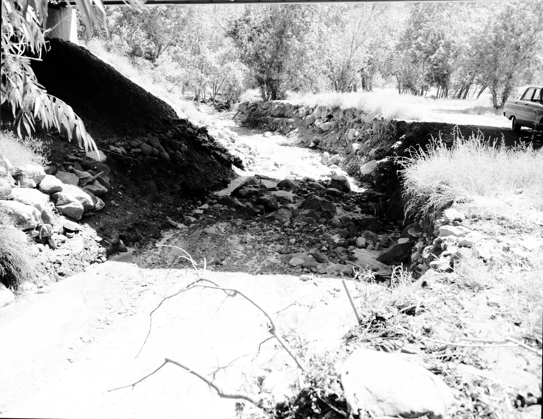 Flood damage - water removed several of the large boulders used as revetments under new Oak Creek bridge.