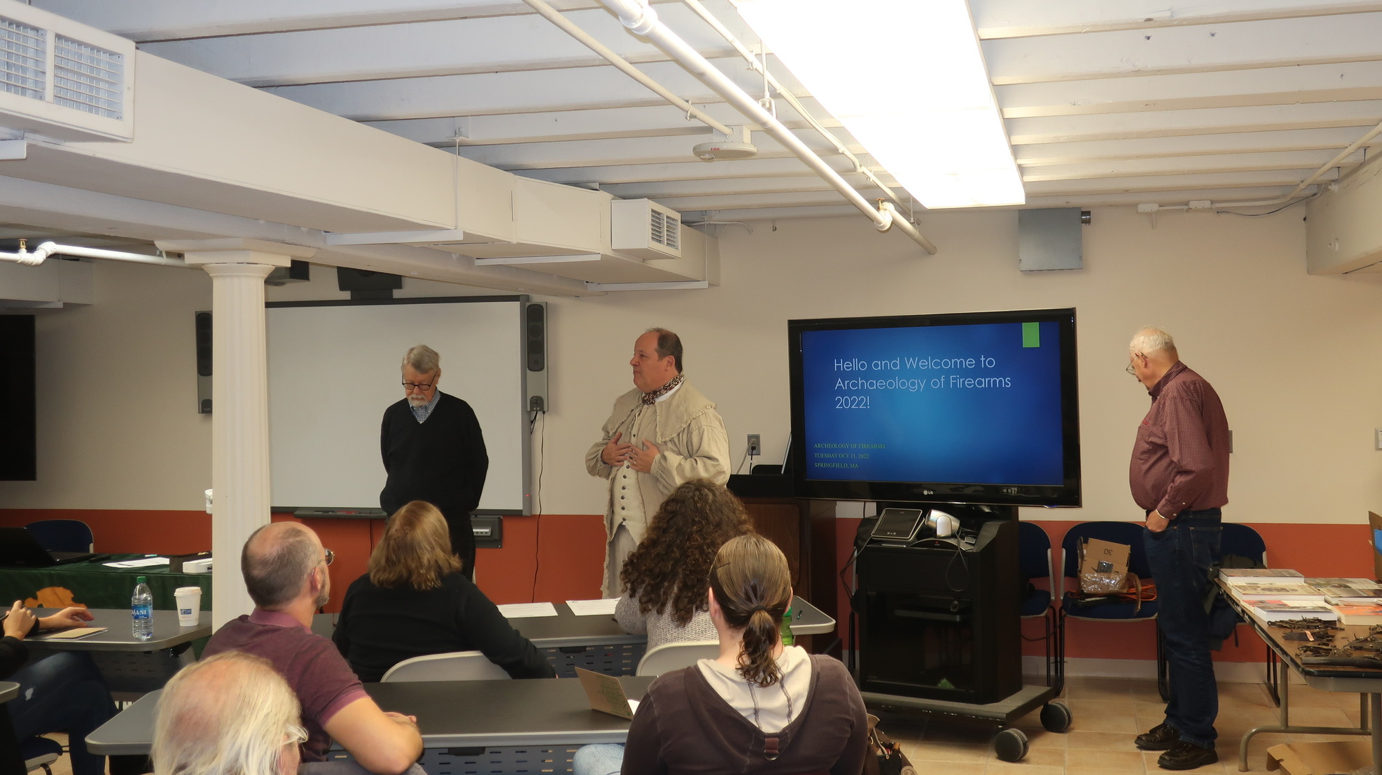 Three men addressing a classroom.