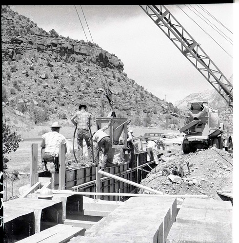 Pouring the cement for the footings of the west wall of the auditorium. Pans for the first floor of concrete in view in the foreground.