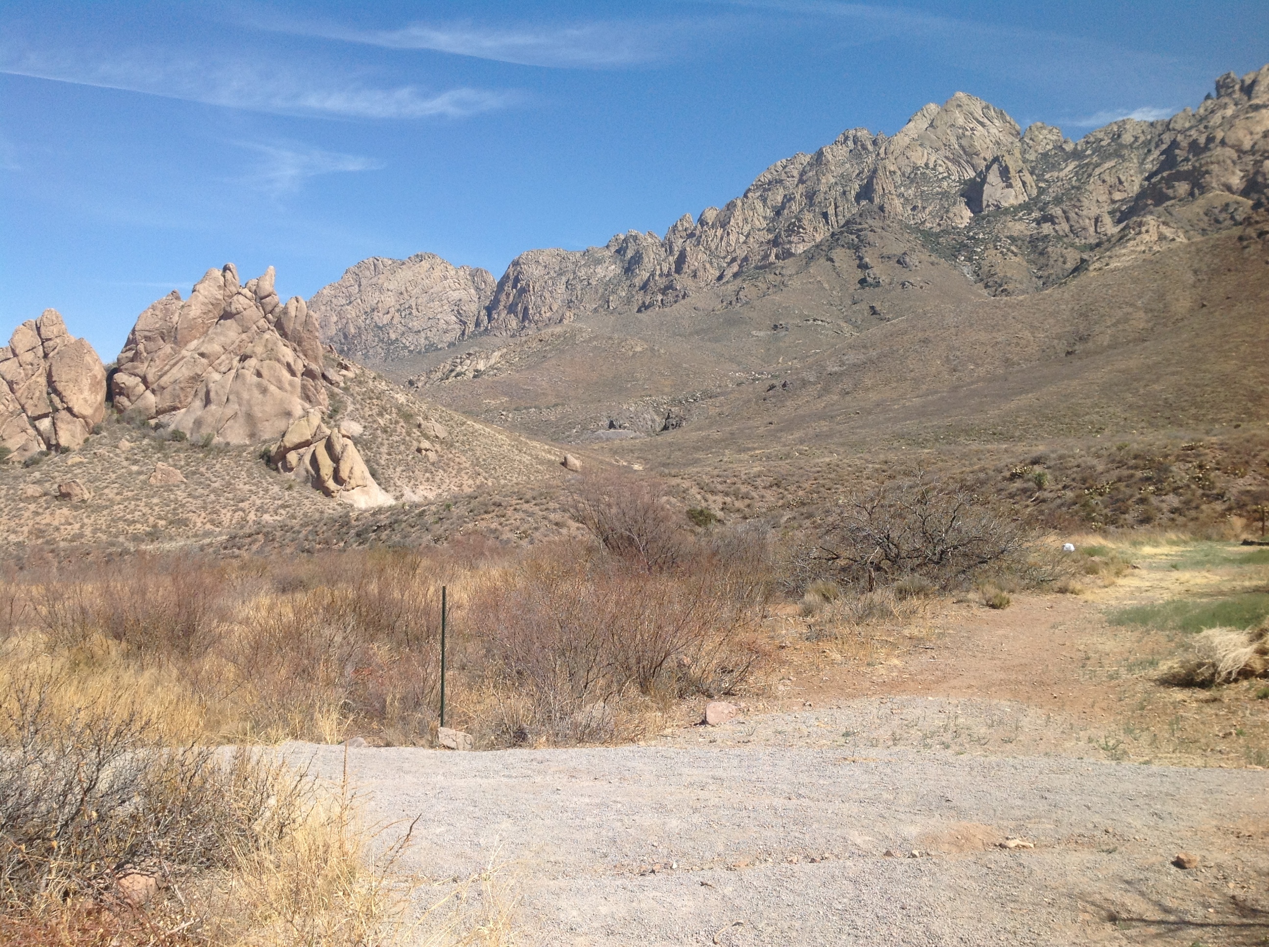 A dirt road with mountains in the background.