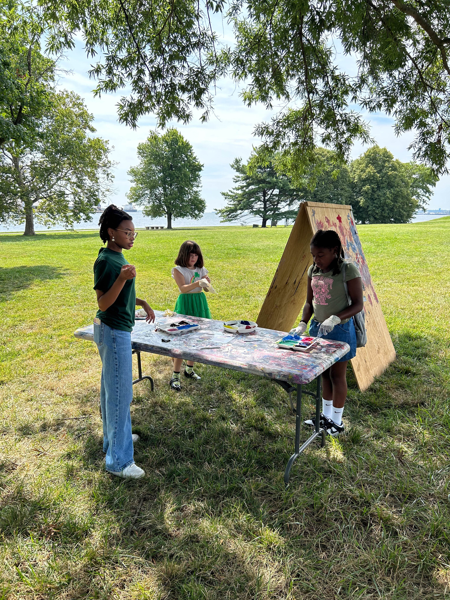 Intern, with two children learning to paint