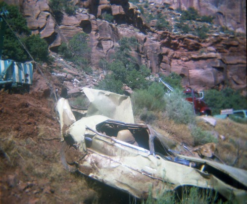 Color photos of park personnel removing a car from the flood waters of the 1975 flood.