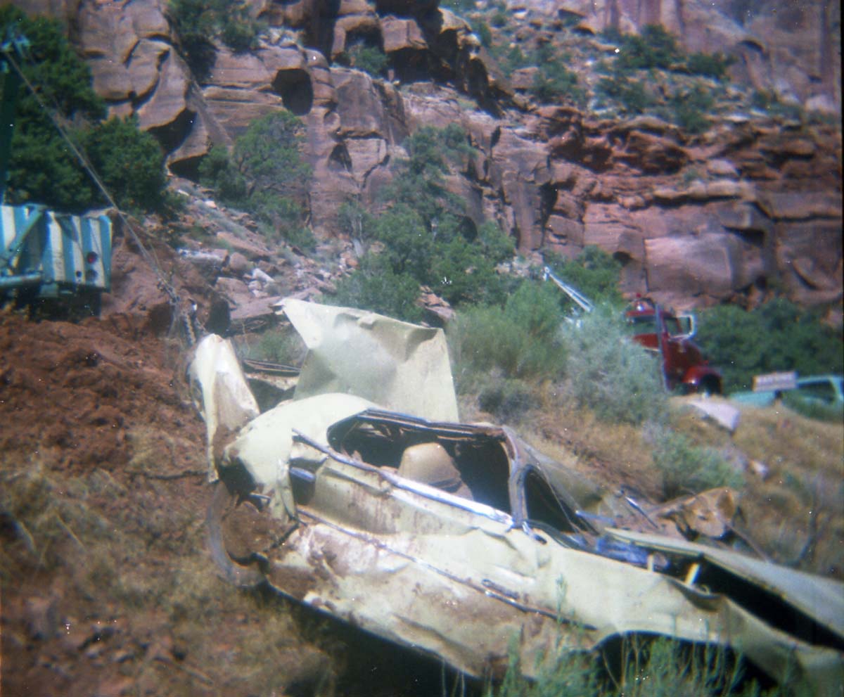 Color photos of park personnel removing a car from the flood waters of the 1975 flood.