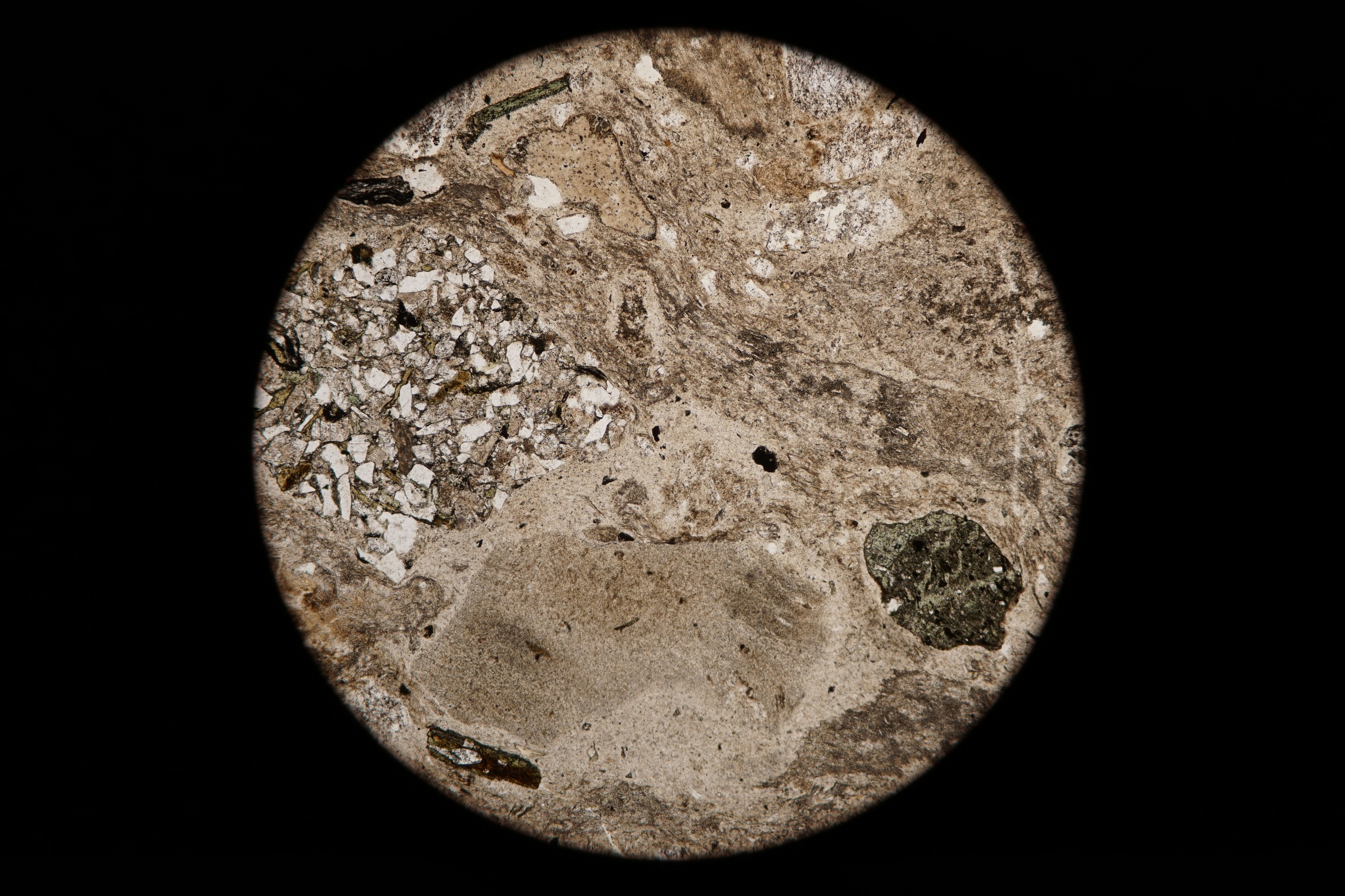 Circular microscopic image of rock structure.