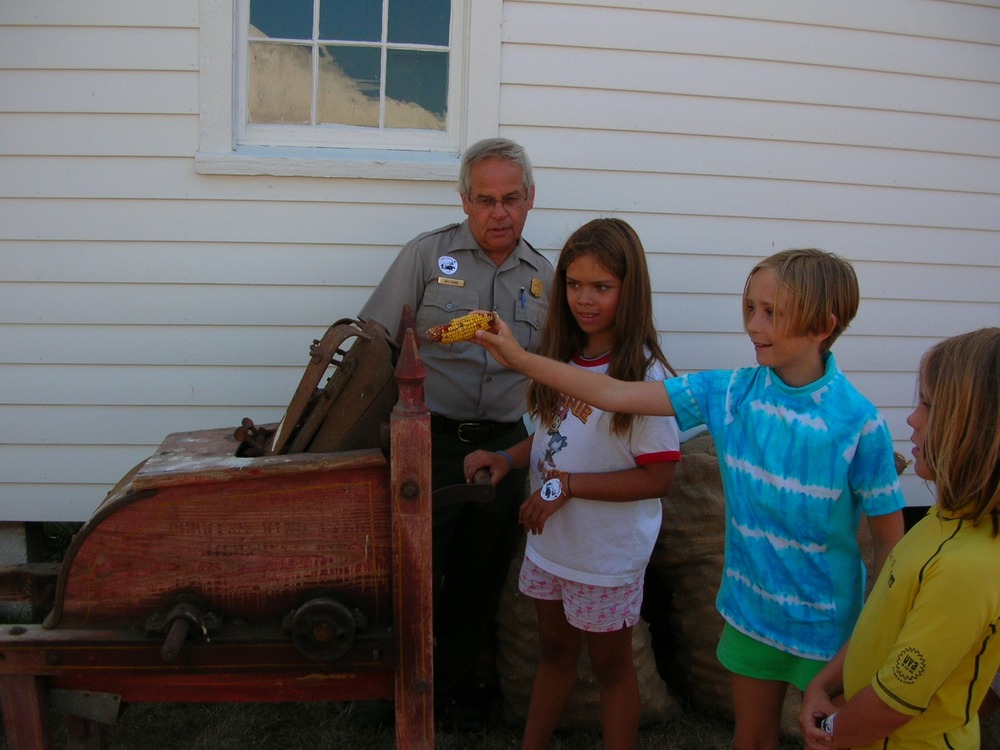 Learning how to shell corn at the Dechow Farm during the 2007 Port Oneida Fair.