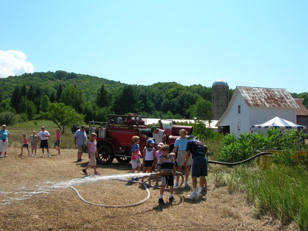 Fire truck demonstration allowed children to "put out the fire" with an old time fire engine.