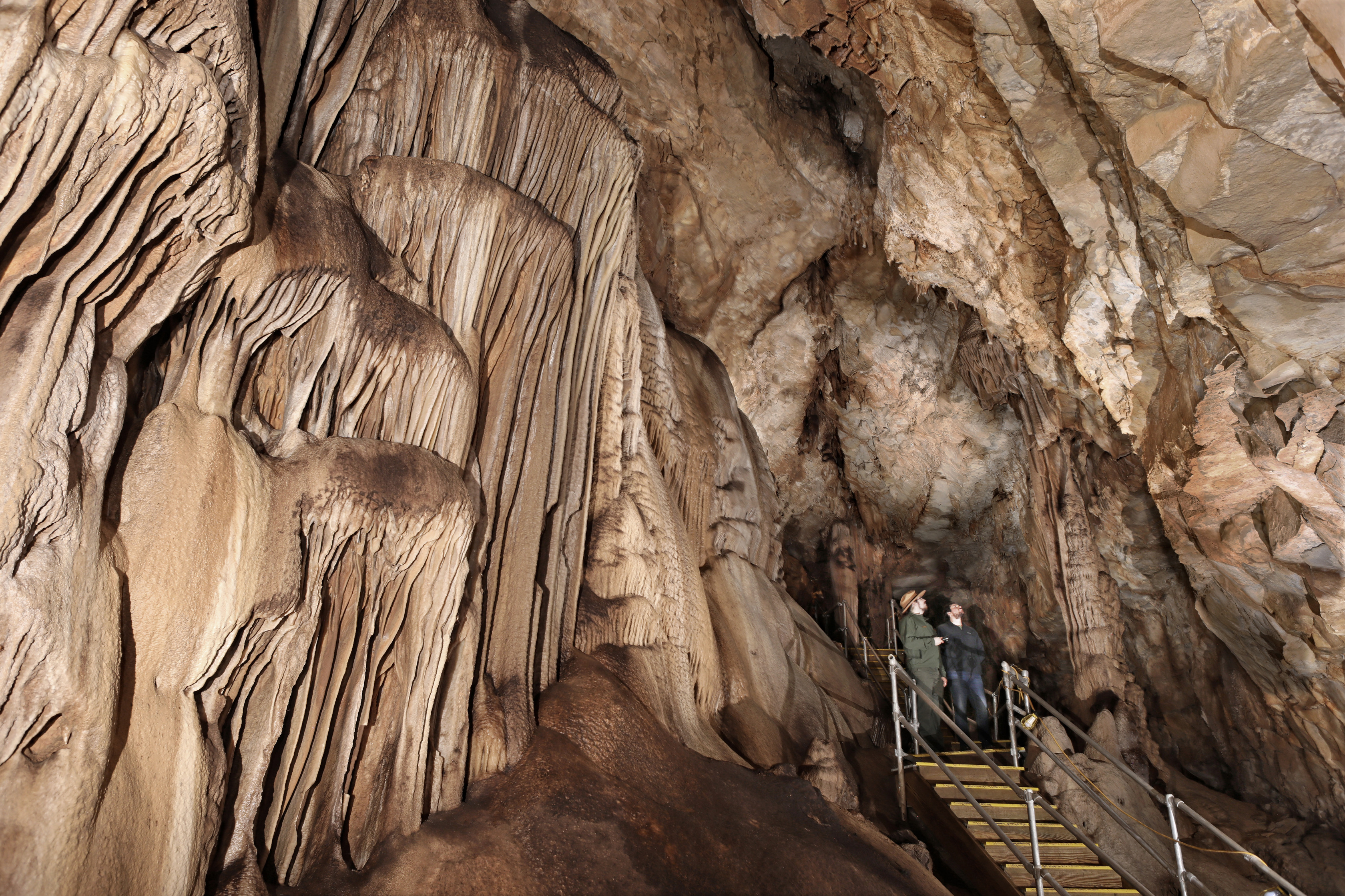 Cavers admiring the formations in cave.