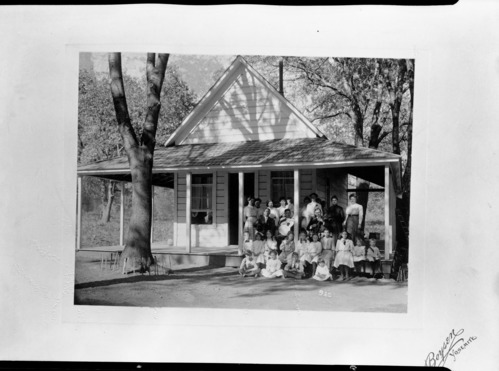 Old schoolhouse with a group of students. From John Dexter collection.