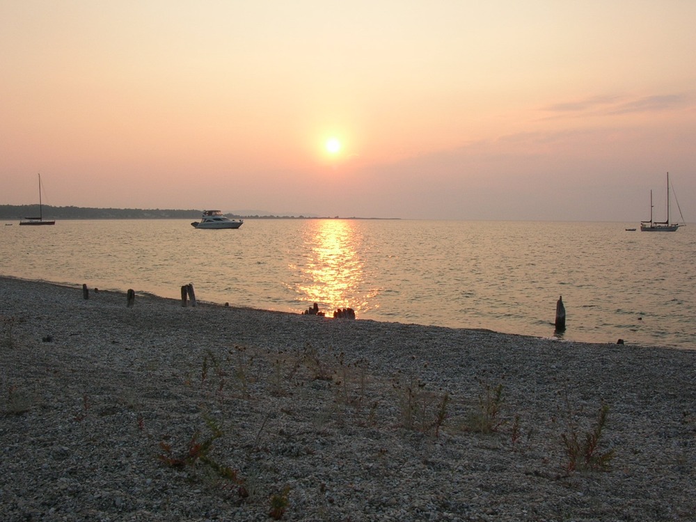 This photo shows the sunrise over Lake Michigan in July at the site of the original dock (Burton's) on South Manitou Island.