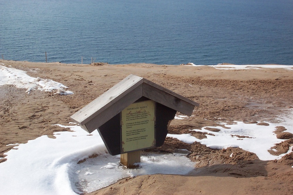 See how the sand has blown up the bluff at the Lake Michigan Overlook on the Pierce Stocking Scenic Drive. This sign was about 5 feet above the ground in the fall, but now in March, it is nearly buried.