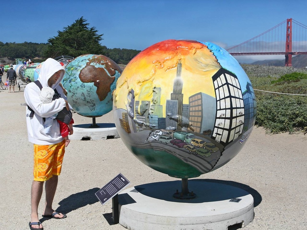 A visitor inspects the Cool Globes exhibition at Crissy Field.