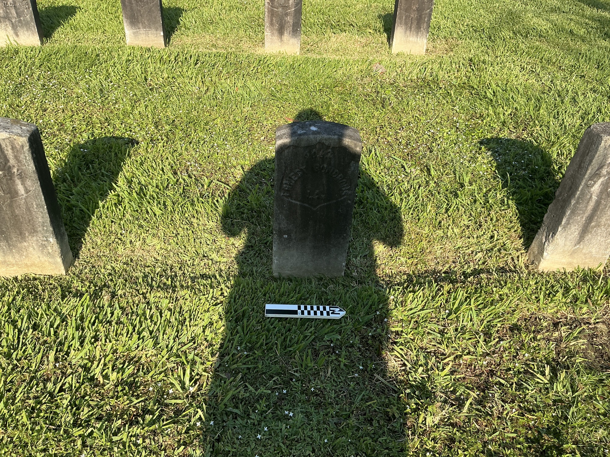 Extra image of historic upright marble headstone with recessed shield face.
