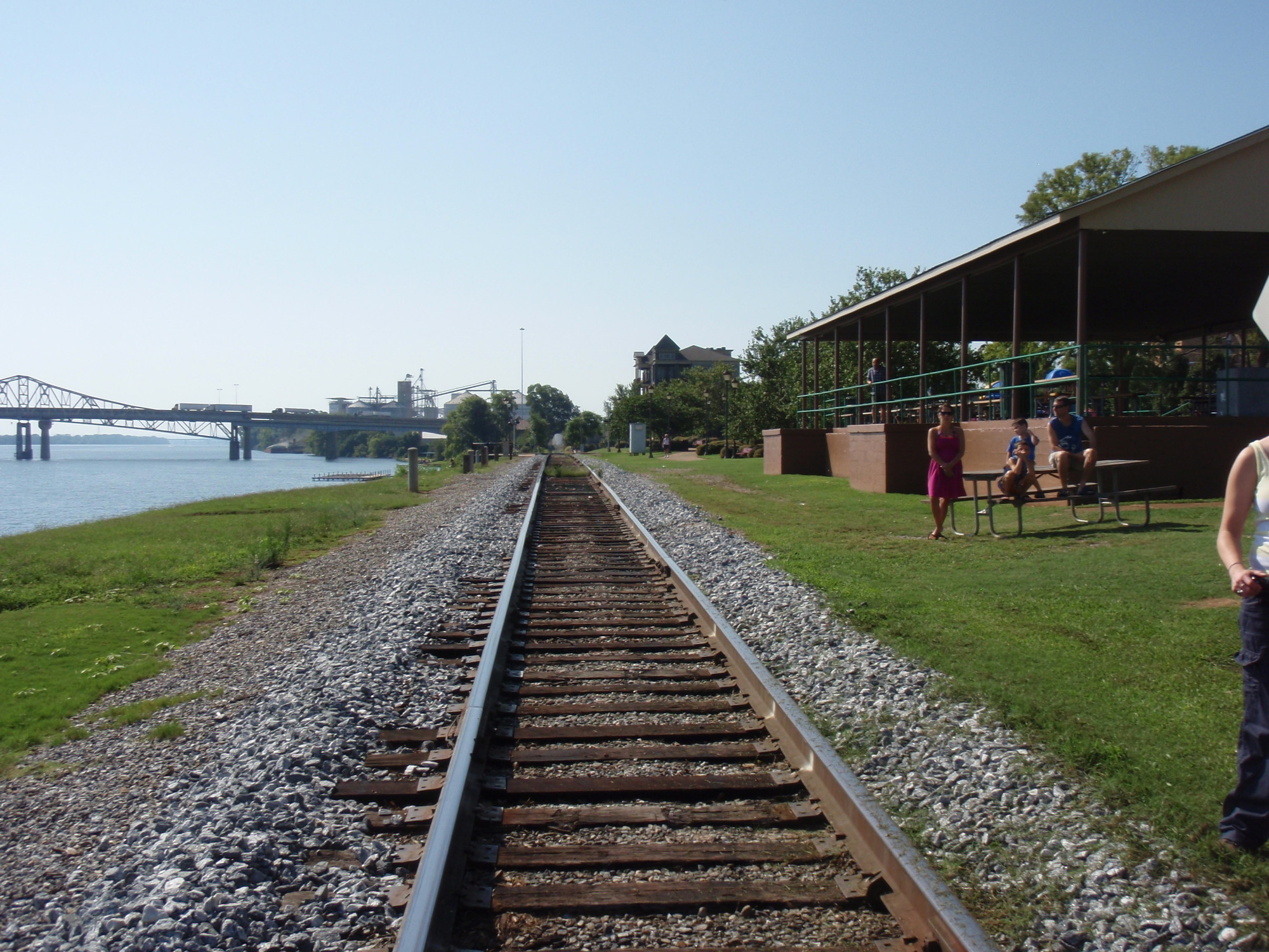 A person standing next to a train track.